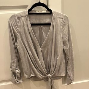 Light blue-gray wrap top with tie. Worn once. Size small.